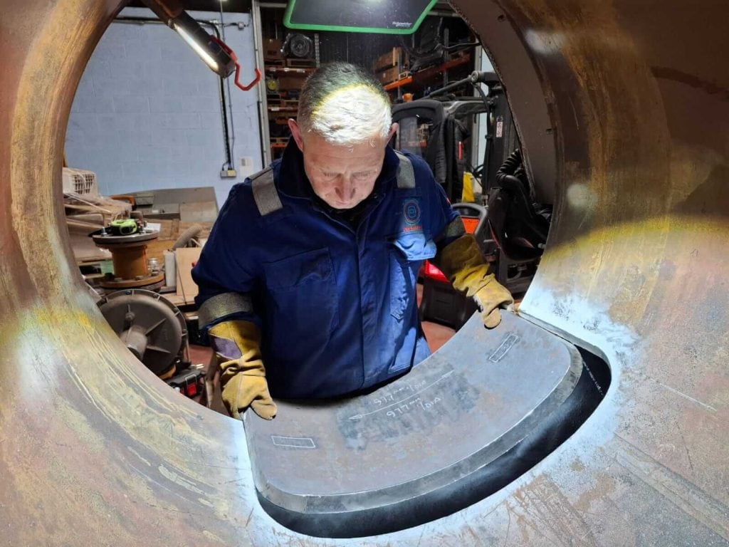 Man at DK Welding Services carefully removing section of metal
