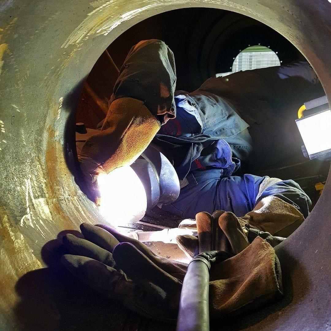 man looking at tube welding and internal access boiler