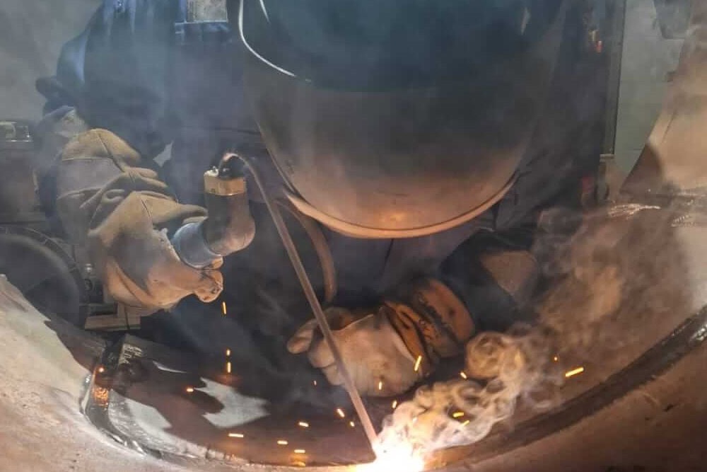 coded welding man demonstrating the skill