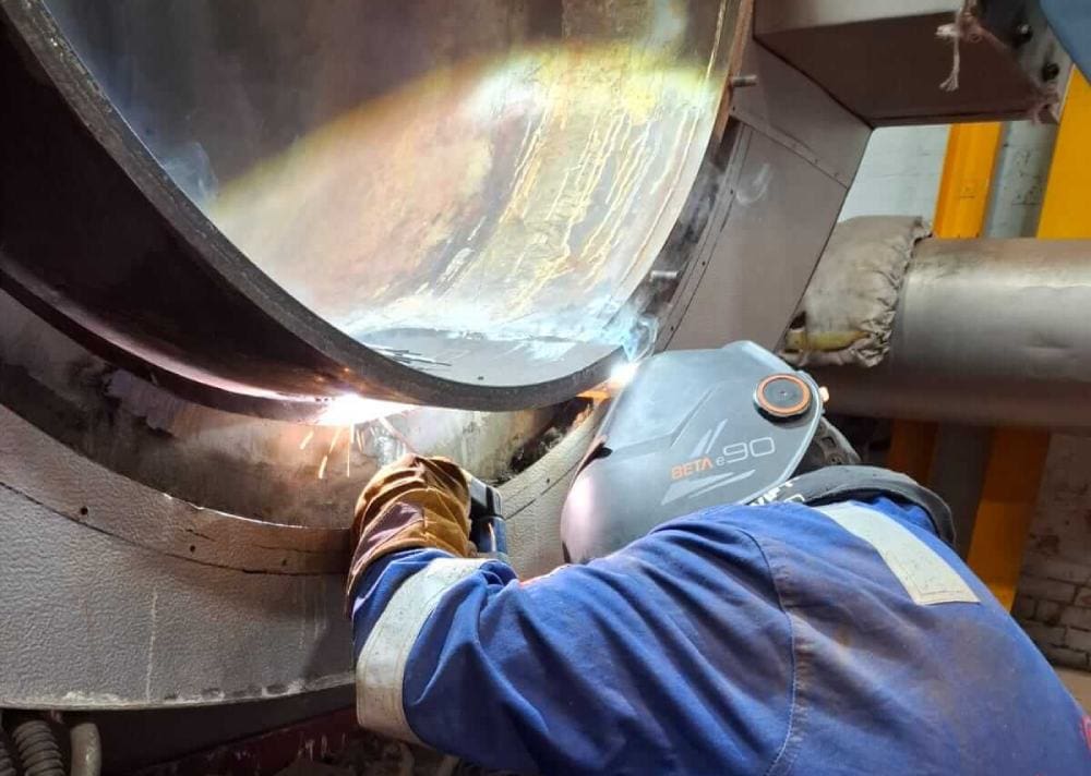 man preparing a boiler for inspection and carrying out repair work